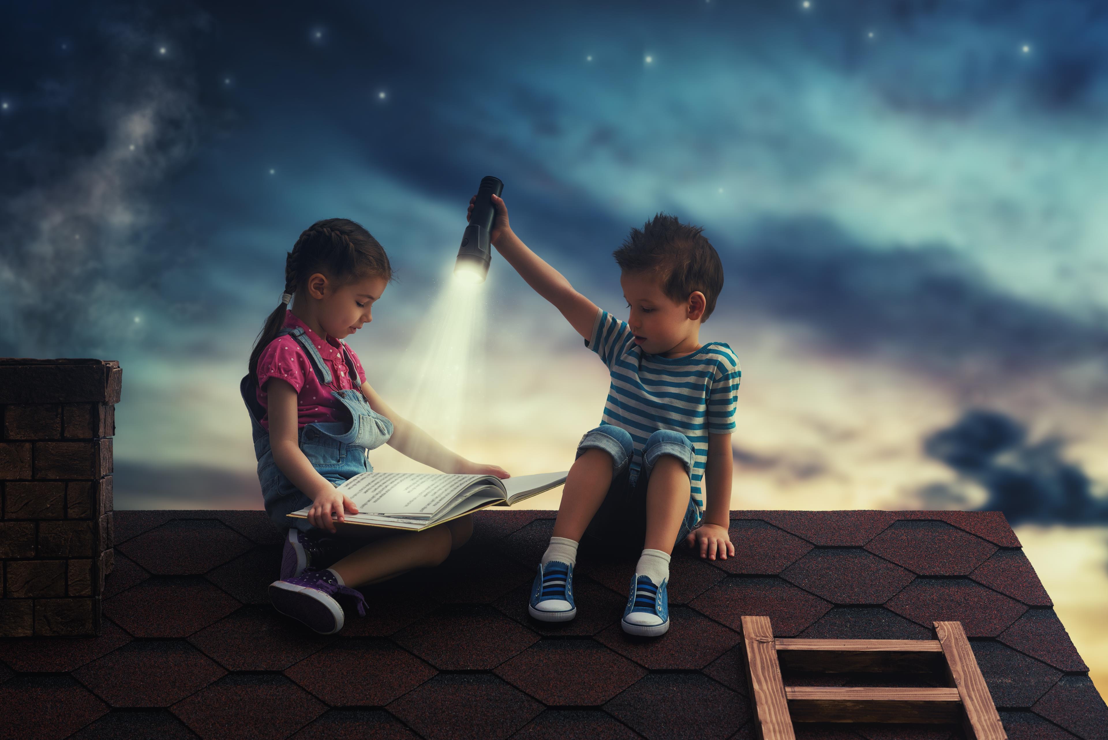 Bambini su un tetto con un libro