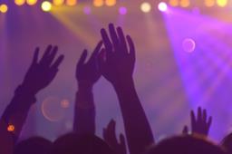 Mani in alto di persone a un concerto